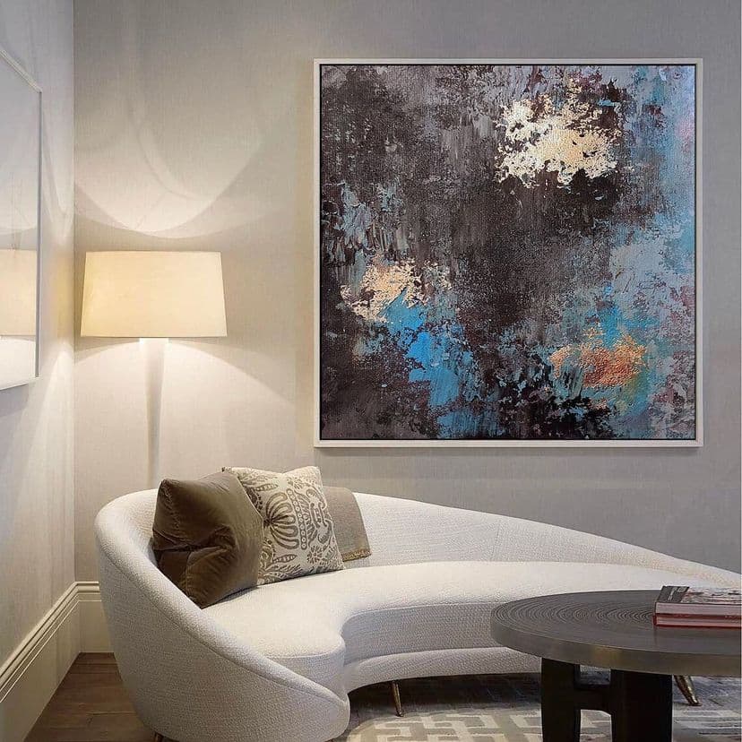 Framed blue and ivory artwork displayed on a studio easel